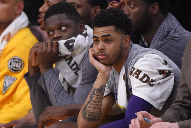 Los Angeles Lakers guard D'Angelo Russell, right, sits on the bench next to forward Julius Randle during the first half of the team's NBA basketball game against the Miami Heat, Wednesday, March 30, 2016, in Los Angeles. (AP Photo/Mark J. Terrill)