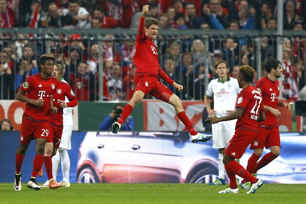 Bayern's Thomas Mueller, center, celebrates after scoring his side's opening goal during the German soccer cup (DFB Pokal) semi final match between FC Bayern Munich and SV Werder Bremen at the Allianz Arena stadium in Munich, Germany, Tuesday, April 19, 2016. (AP Photo/Matthias Schrader)