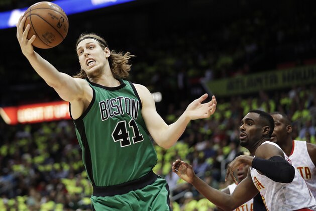 Boston Celtics' Kelly Olynyk, left, grabs a rebound in front of Atlanta Hawks' Tim Hardaway Jr., right, during the first quarter in Game 1 of a first-round NBA basketball playoff series Saturday, April 16, 2016, in Atlanta. (AP Photo/David Goldman)