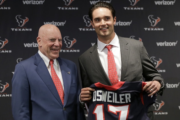 Houston Texans quarterback Brock Osweiler, right, holds his new jersey as he poses with owner Bob McNair during a news conference Thursday, March 10, 2016, in Houston. The Texans have filled their biggest need, starting free agency with a splash by snagging Osweiler from Denver. (AP Photo/David J. Phillip)