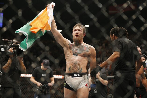 Conor McGregor celebrates after defeating Chad Mendes during their interim featherweight title mixed martial arts bout at UFC 189 Saturday, July 11, 2015, in Las Vegas. (AP Photo/John Locher)