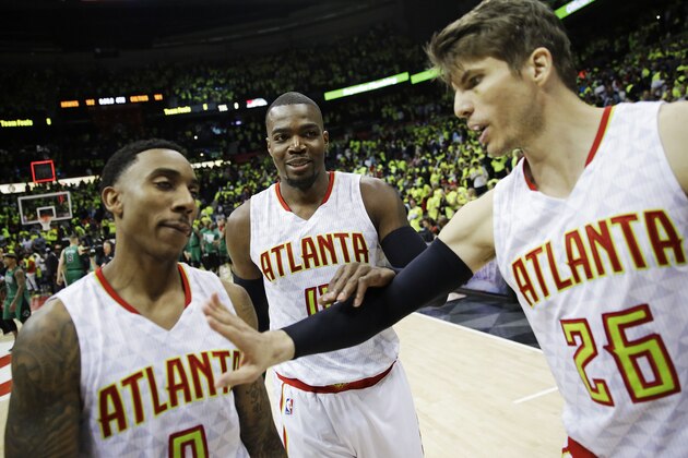 Atlanta Hawks' Paul Millsap, center, joins teammates Jeff Teague, left, and Kyle Korver as they walk off the court after the Hawks beat the Boston Celtics 102-101 in Game 1 of a first-round NBA basketball playoff series Saturday, April 16, 2016, in Atlanta. (AP Photo/David Goldman)