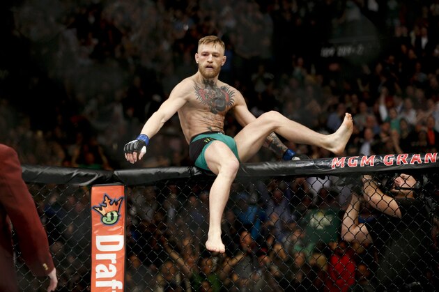 Conor McGregor reacts after defeating Jose Aldo during a featherweight  championship mixed martial arts bout at UFC 194, Saturday, Dec. 12, 2015, in Las Vegas. (AP Photo/John Locher)