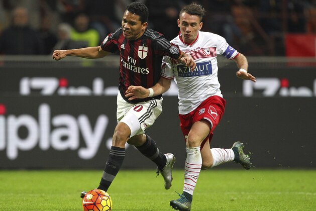 MILAN, ITALY - JANUARY 13:  Carlos Bacca of AC Milan competes for the ball with Gaetano Letizia of Carpi FC during the TIM Cup match between AC Milan and Carpi FC at Stadio Giuseppe Meazza on January 13, 2016 in Milan, Italy.  (Photo by Marco Luzzani/Getty Images)