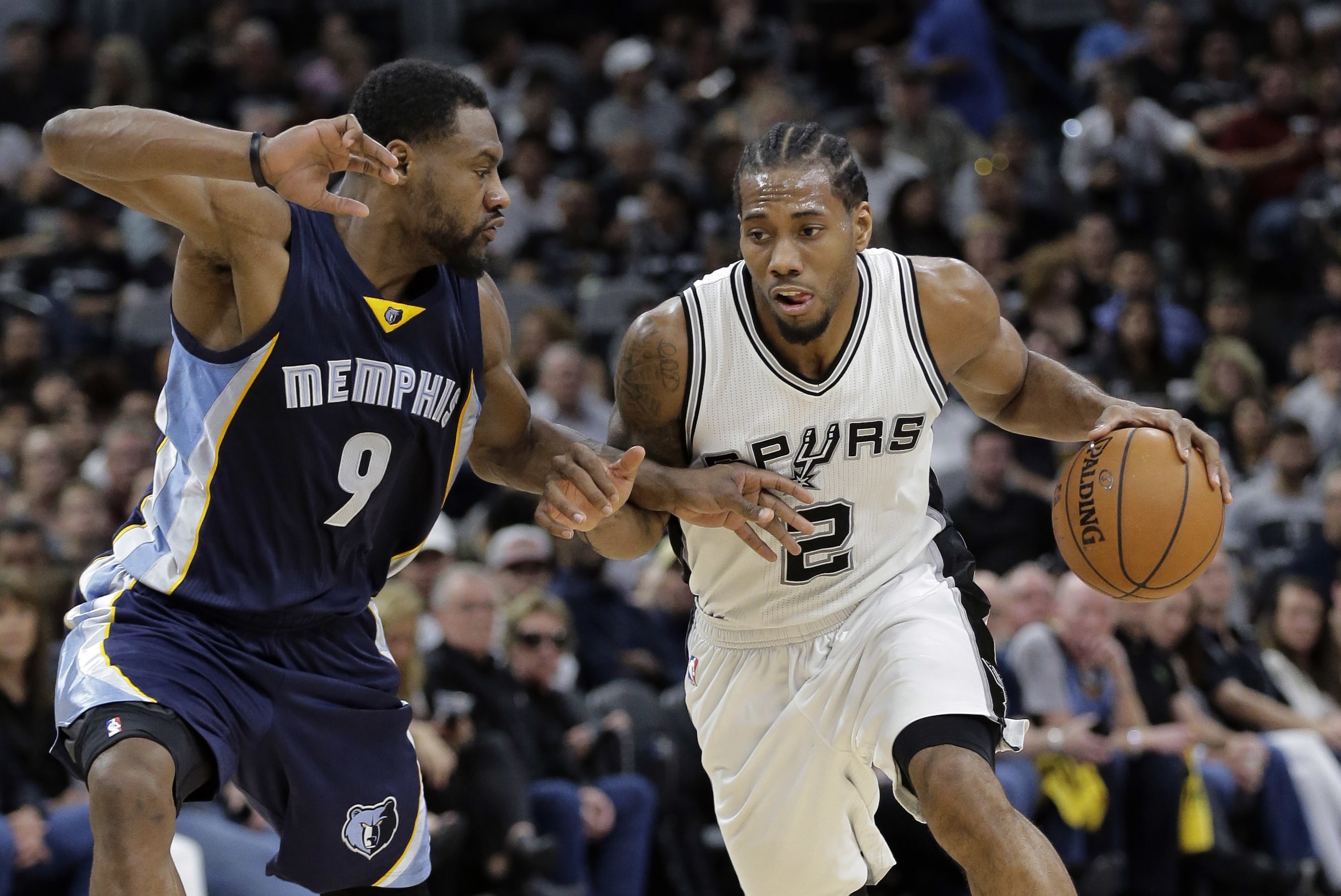 San Antonio Spurs forward Kawhi Leonard (2) drives around Memphis Grizzlies guard Tony Allen (9) during Game 2 of a first-round NBA basketball playoff series, Tuesday, April 19, 2016, in San Antonio, Texas. (AP Photo/Eric Gay)