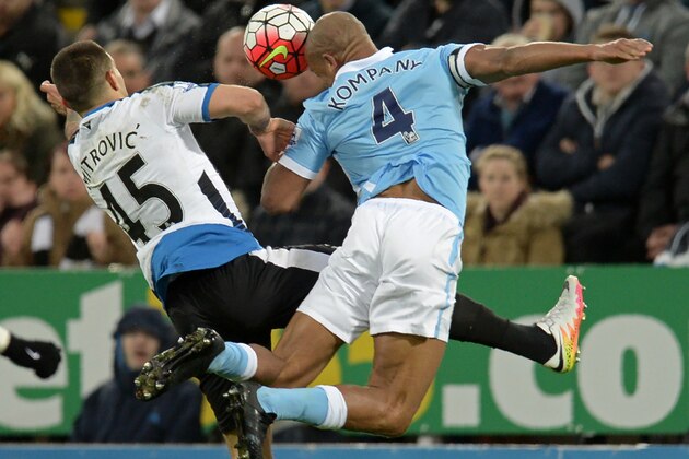 Manchester City's Belgian defender Vincent Kompany (R) vies with Newcastle United's Serbian striker Aleksandar Mitrovic during the English Premier League football match between Newcastle United and Manchester City at St James' Park in Newcastle-upon-Tyne, north east England on April 19, 2016. / AFP / OLI SCARFF / RESTRICTED TO EDITORIAL USE. No use with unauthorized audio, video, data, fixture lists, club/league logos or 'live' services. Online in-match use limited to 75 images, no video emulation. No use in betting, games or single club/league/player publications.  /         (Photo credit should read OLI SCARFF/AFP/Getty Images)