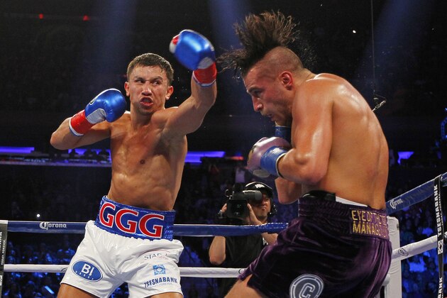 Gennady Golovkin, left, hits David Lemieux in the second round of a middleweight title fight at Madison Square Garden in New York on Saturday, Oct. 17, 2015. Golovkin won in the eighth round. (AP Photo/Rich Schultz)