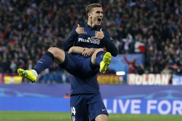 Atletico's scorer Antoine Griezmann is lifted by his teammate Atletico's Gabi Fernandez, as they celebrate the opening goal during the Champions League 2nd leg quarterfinal soccer match between Atletico Madrid and Barcelona at the Vicente Calderon stadium in Madrid, Spain, Wednesday April 13, 2016. (AP Photo/Paul White)