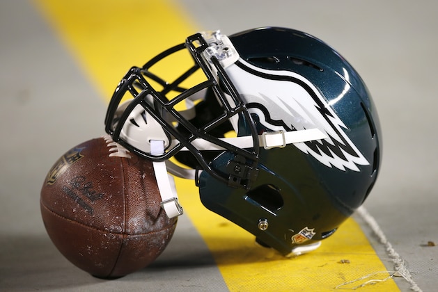An Philadelphia Eagles helmet rests on a football on the bench prior to an NFL football game between the Eagles and the New York Giants, Sunday, Oct. 12, 2014, in Philadelphia. (AP Photo/Michael Perez)
