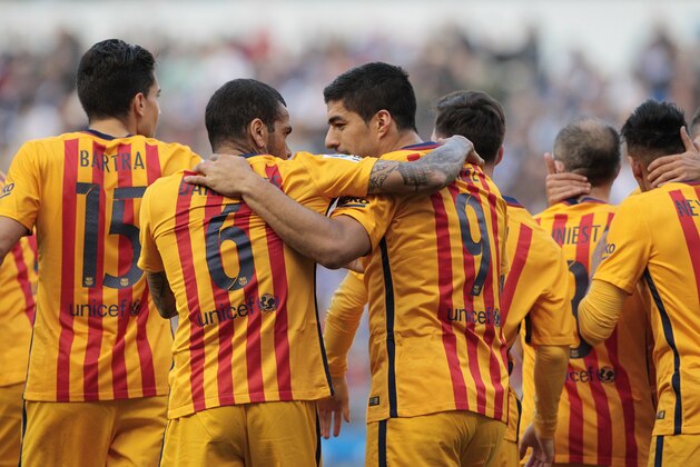 Barcelona's Luis Suarez, center right, is congratulated by teammates after scoring the second goal during a Spanish La Liga soccer match between Deportivo Coruna and Barcelona at the Riazor stadium in A Coruna, Spain, Wednesday, April 20, 2016. (AP Photo/Lalo R. Villar)