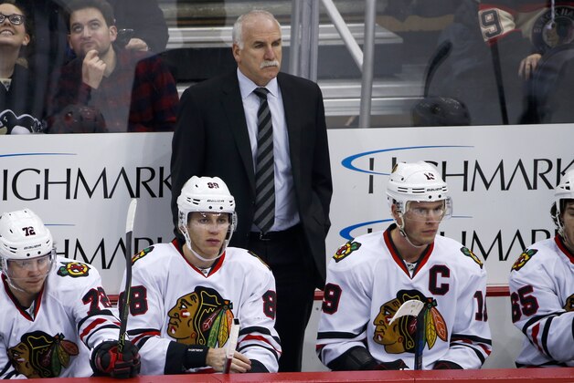 Chicago Blackhawks' Jonathan Toews (19) and Patrick Kane (88) sit on the bench in front of head coach Joel Quenneville during an NHL hockey game against the Pittsburgh Penguins in Pittsburgh, Tuesday, Jan. 5, 2016. (AP Photo/Gene J. Puskar)