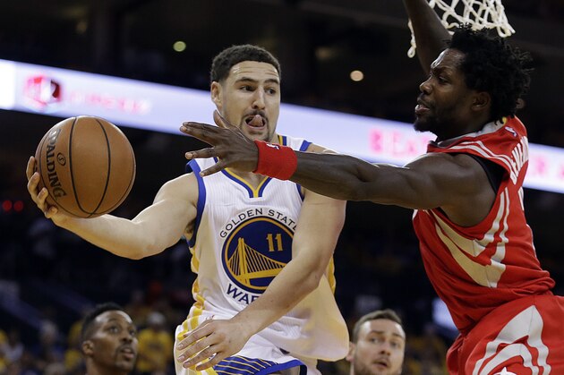 Golden State Warriors' Klay Thompson (11) looks to pass away from Houston Rockets' Patrick Beverley, right, during the second half in Game 2 of a first-round NBA basketball playoff series Monday, April 18, 2016, in Oakland, Calif. The Warriors won, 115-106. (AP Photo/Ben Margot)