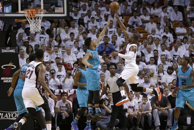 Miami Heat guard Dwyane Wade shoots over Charlotte Hornets guard Courtney Lee during the second half of Game 2 of a first-round NBA basketball playoff series, Wednesday, April 20, 2016, in Miami. (AP Photo/Alan Diaz)