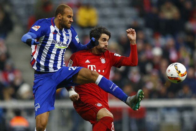 Berlin's John Anthony Brooks, left, and Bayern's Javi Martinez challenge for the ball during the German Bundesliga soccer match between FC Bayern Munich and Hertha BSC Berlin at the Allianz Arena stadium in Munich, Germany, Saturday, Nov. 28, 2015. (AP Photo/Matthias Schrader)