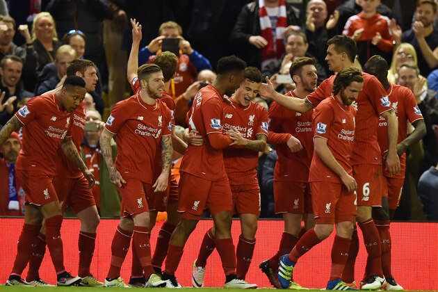 Liverpool's Brazilian midfielder Philippe Coutinho (C) celebrates with Liverpool's English striker Daniel Sturridge (C-L) and teammates after scoring their fourth goal during the English Premier League football match between Liverpool and Everton at Anfield in Liverpool, north west England on April 20, 2016. / AFP / PAUL ELLIS / RESTRICTED TO EDITORIAL USE. No use with unauthorized audio, video, data, fixture lists, club/league logos or 'live' services. Online in-match use limited to 75 images, no video emulation. No use in betting, games or single club/league/player publications.  /         (Photo credit should read PAUL ELLIS/AFP/Getty Images)