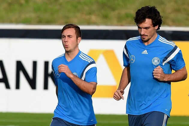 Germany's defender Mats Hummels (C), Germany's forward Andre Schuerrle (R) and Germany's forward Mario Goetze warm up during a training session of the German national football team in Essen, Germany on October 13, 2014. Germany's squad prepares for the upcoming European Qualifier match against Ireland on October 14, 2014 in Gelsenkirchen. AFP PHOTO / PATRIK STOLLARZ        (Photo credit should read PATRIK STOLLARZ/AFP/Getty Images)