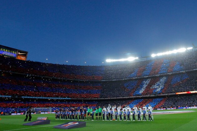 Fans hold up a mosaic of 90,000 cards with a number 14 jersey while a screen reads in Catalan: ‘Thank you Johan' during a tribute to the late Dutch soccer star Johan Cruyff at the beginning of a Spanish La Liga soccer match between Barcelona and Real Madrid, dubbed 'el clasico', at the Camp Nou stadium in Barcelona, Spain, Saturday, April 2, 2016. (AP Photo/Manu Fernandez)