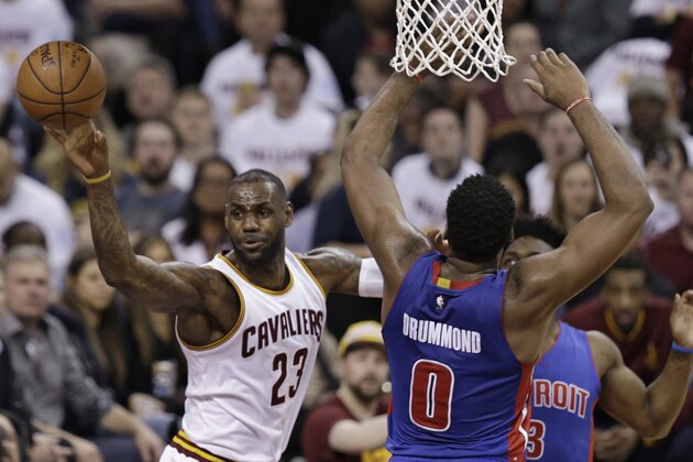 Cleveland Cavaliers' LeBron James (23) passes around Detroit Pistons' Andre Drummond (0) in the first half in Game 2 of a first-round NBA basketball playoff series, Wednesday, April 20, 2016, in Cleveland. (AP Photo/Tony Dejak)