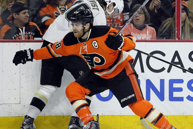 Philadelphia Flyers' Claude Giroux (28) checks Pittsburgh Penguins' Oscar Sundqvist into the boards during the second period of an NHL hockey game Saturday, April 9, 2016 in Philadelphia. (AP Photo/Tom Mihalek)