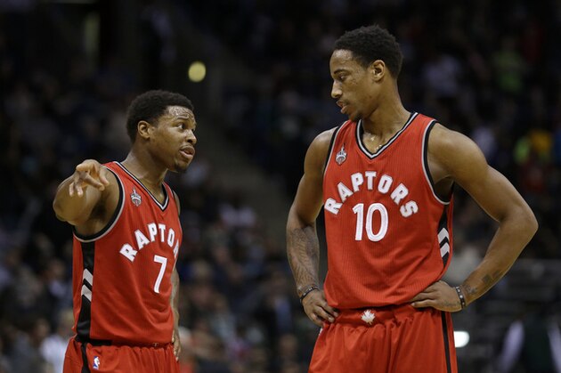 Toronto Raptors' Kyle Lowry (7) talks with DeMar DeRozan (10) during an NBA basketball game against the Milwaukee Bucks Saturday, Dec. 26, 2015, in Milwaukee. (AP Photo/Aaron Gash)