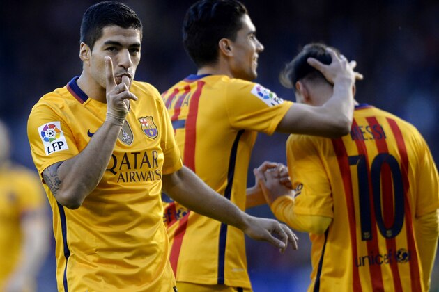 Barcelona's Uruguayan forward Luis Suarez (L) celebrates his third goal during the Spanish league football match RC Deportivo de la Coruna vs FC Barcelona at the Municipal de Riazor stadium in La Coruna on April 20, 2016. / AFP / MIGUEL RIOPA        (Photo credit should read MIGUEL RIOPA/AFP/Getty Images)