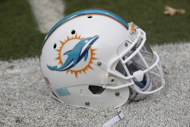 A Miami Dolphins helmet in placed on the sidelines before an NFL football game against the Buffalo Bills, Sunday, Sept. 27, 2015 in Miami Gardens, Fla. (AP Photo/Wilfredo Lee)