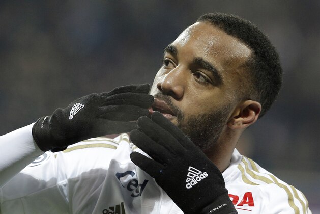 Lyon's Alexandre Lacazette celebrates after scoring a goal  during the French League One soccer match between Lyon and Guingamp in Decines, near Lyon, central France, Sunday, March 6, 2016. (AP Photo/Laurent Cipriani)