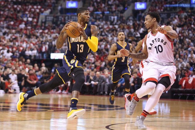TORONTO, CANADA - APRIL 16: Paul George #13 of the Indiana Pacers drives to the basket as DeMar DeRozan #10 of the Toronto Raptors tries to defend in Game One of the Eastern Conference Quarterfinals during the 2016 NBA Playoffs on April 16, 2016 at the Air Canada Centre in Toronto, Ontario, Canada. NOTE TO USER: User expressly acknowledges and agrees that, by downloading and or using this photograph, User is consenting to the terms and conditions of the Getty Images License Agreement. (Photo by Tom Szczerbowski/Getty Images)