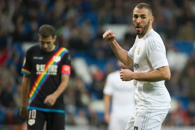 Real Madrid's French forward Karim Benzema celebrates after scoring during the Spanish league football match Real Madrid CF vs Rayo Vallecano de Madrid at the Santiago Bernabeu stadium in Madrid on December 20, 2015. Real Madrid won 10-2.   / AFP / CURTO DE LA TORRE        (Photo credit should read CURTO DE LA TORRE/AFP/Getty Images)