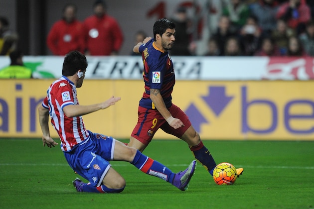 GIJON, SPAIN - FEBRUARY 17:  Luis Suarez of FC Barcelona is tackled by Alex Barrera of Sporting Gijon during the La Liga match between Sporting Gijon and FC Barcelona at Estadio El Molinon on February 17, 2016 in Gijon, Spain.  (Photo by Denis Doyle/Getty Images)
