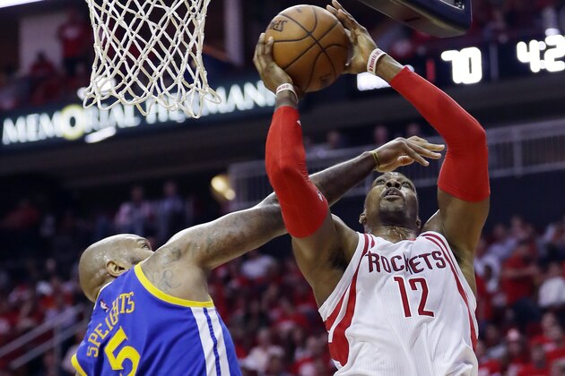 Houston Rockets center Dwight Howard, right, shoots over Golden State Warriors center Marreese Speights during the first half in Game 3 of a first-round NBA basketball playoff series, Thursday, April 21, 2016, in Houston. (AP Photo/David J. Phillip)