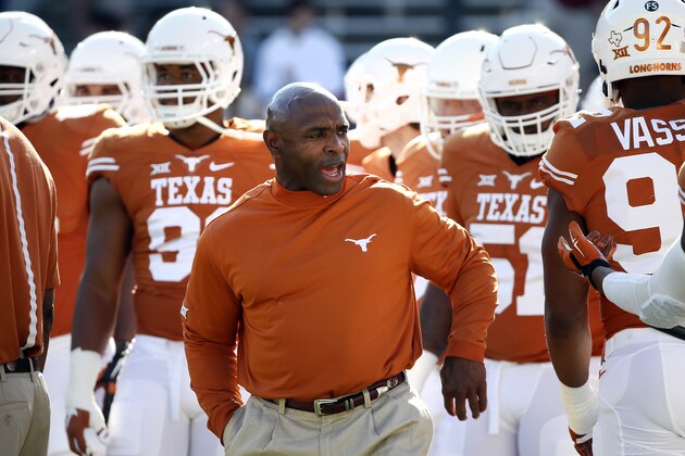 FILE - In this Oct. 10, 2015, file photo, Texas head coach Charlie Strong talks with his team during warm ups before an NCAA college football game against Oklahoma in Dallas. To turnaround Texas, coach Strong has to be able to recruit in the state at a time when it has never been more competitive. (AP Photo/Tony Gutierrez, File)