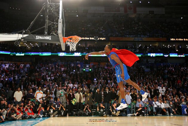 NEW ORLEANS - FEBRUARY 16:  Dwight Howard #12 of the Orlando Magic completes his Superman dunk during the Sprite Slam Dunk Contest part of 2008 NBA All-Star Weekend at the New Orleans Arena on February 16, 2008 in New Orleans, Louisiana.  NOTE TO USER: User expressly acknowledges and agrees that, by downloading and or using this photograph, User is consenting to the terms and conditions of the Getty Images License Agreement. Mandatory Copyright Notice: Copyright 2008 NBAE  (Photo by Jesse D. Garrabrant/NBAE/Getty Images)
