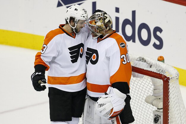 Apr 22, 2016; Washington, DC, USA; Philadelphia Flyers goalie Michal Neuvirth (30) celebrates with Flyers defenseman Brandon Manning (23) after their game against the Washington Capitals in game five of the first round of the 2016 Stanley Cup Playoffs at Verizon Center. The Flyers won 2-0, and the Capitals lead the series 3-2. Mandatory Credit: Geoff Burke-USA TODAY Sports