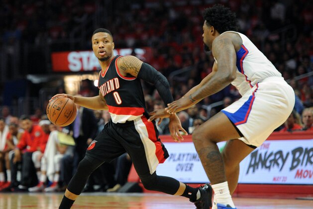 April 20, 2016; Los Angeles, CA, USA; Portland Trail Blazers guard Damian Lillard (0) moves the ball against Los Angeles Clippers center DeAndre Jordan (6) during the first half at Staples Center. Mandatory Credit: Gary A. Vasquez-USA TODAY Sports