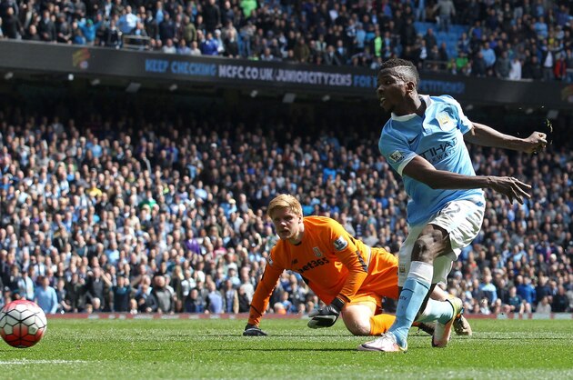 Manchester City's Nigerian striker Kelechi Iheanacho goes around Stoke City's Danish goalkeeper Jakob Haugaard (L) to score their fourth goal during the English Premier League football match between Manchester City and Stoke City at the Etihad Stadium in Manchester, north west England, on April 23, 2016. / AFP / LINDSEY PARNABY / RESTRICTED TO EDITORIAL USE. No use with unauthorized audio, video, data, fixture lists, club/league logos or 'live' services. Online in-match use limited to 75 images, no video emulation. No use in betting, games or single club/league/player publications.  /         (Photo credit should read LINDSEY PARNABY/AFP/Getty Images)