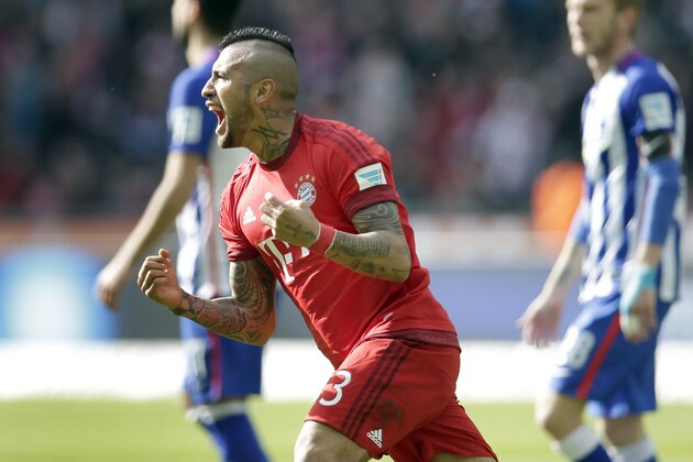 Bayern's Arturo Vidal, front, celebrates after scoring the opening goal during the German Bundesliga soccer match between Hertha BSC Berlin and FC Bayern Munich in Berlin, Germany, Saturday, April 23, 2016. (AP Photo/Michael Sohn)