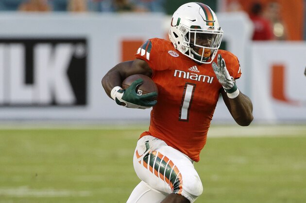 Miami running back Mark Walton (1) runs for yardage during the second half of an NCAA college football game against Nebraska, Saturday, Sept. 19, 2015 in Miami Gardens, Fla. Miami defeated Nebraska 36-33 in overtime. (AP Photo/Wilfredo Lee)