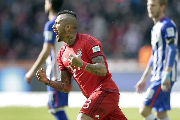 Bayern's Arturo Vidal, front, celebrates after scoring the opening goal during the German Bundesliga soccer match between Hertha BSC Berlin and FC Bayern Munich in Berlin, Germany, Saturday, April 23, 2016. (AP Photo/Michael Sohn)