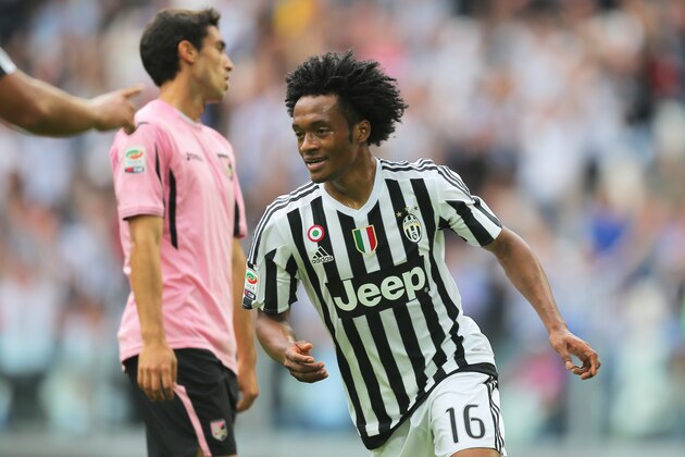 Juventus' midfielder Juan Cuadrado from Colombia celebrates after scoring with Juventus' defender Patrice Evra from France during the Italian Serie A football match Juventus vs Palermo on April 17, 2016 at the Juventus stadium in Turin.  / AFP / MARCO BERTORELLO        (Photo credit should read MARCO BERTORELLO/AFP/Getty Images)