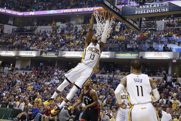 Apr 23, 2016; Indianapolis, IN, USA; Indiana Pacers forward Paul George (13) dunks against Toronto Raptors guard Kyle Lowry (7) during the first quarter in game four of the first round of the 2016 NBA Playoffs at Bankers Life Fieldhouse. Mandatory Credit: Brian Spurlock-USA TODAY Sports
