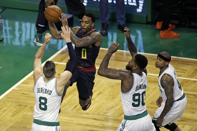 Atlanta Hawks guard Jeff Teague (0) drives to the basket against Boston Celtics forward Jonas Jerebko (8), forward Jae Crowder (99) and guard Isaiah Thomas (4) during the first quarter in Game 3 of a first-round NBA basketball playoff series Friday, April 22, 2016, in Boston. (AP Photo/Elise Amendola)