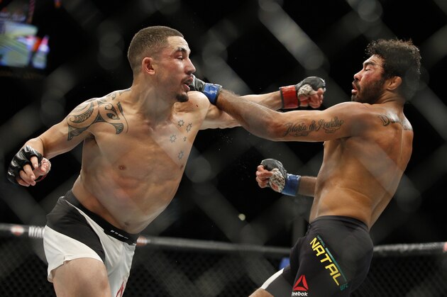 Robert Whittaker, left, hits Rafael Natal during a middleweight mixed martial arts bout at UFC 197, Saturday, April 23, 2016, in Las Vegas. (AP Photo/John Locher)