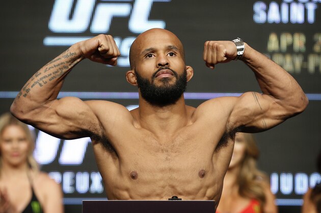 Demetrious Johnson poses on the scale during a weigh-in for UFC 197, Friday, April 22, 2016, in Las Vegas. Johnson is scheduled to fight Henry Cejudo in a flyweight title fight Saturday in Las Vegas. (AP Photo/John Locher)