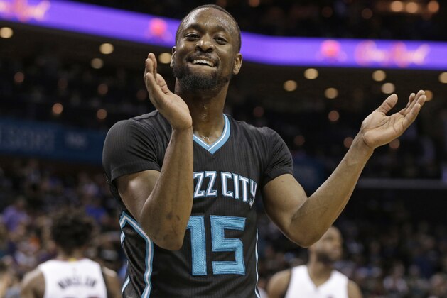 Charlotte Hornets' Kemba Walker (15) celebrates after making a basket against the Miami Heat during the second half in Game 3 of an NBA basketball playoffs first-round series in Charlotte, N.C., Saturday, April 23, 2016. The Hornets won 96-80. (AP Photo/Chuck Burton)