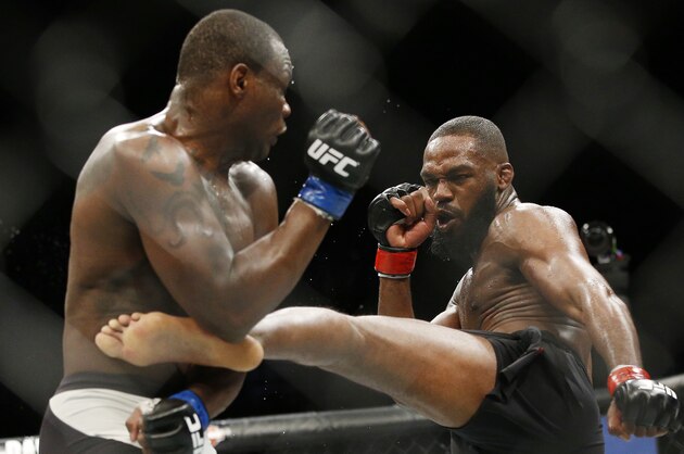 Jon Jones, right, kicks Ovince Saint Preux during an interim light heavyweight championship mixed martial arts bout at UFC 197, Saturday, April 23, 2016, in Las Vegas. (AP Photo/John Locher)