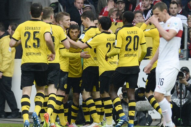 Dortmund's US midfielder Christian Pulisic (C) is congratulated by teammates after he scored during the German first division Bundesliga football match between VfB Stuttgart and Borussia Dortmund in the Mercedes-Benz Arena in Stuttgart, southwestern Germany, on April 23, 2016.  / AFP / THOMAS KIENZLE / RESTRICTIONS: DURING MATCH TIME: DFL RULES TO LIMIT THE ONLINE USAGE TO 15 PICTURES PER MATCH AND FORBID IMAGE SEQUENCES TO SIMULATE VIDEO. == RESTRICTED TO EDITORIAL USE == FOR FURTHER QUERIES PLEASE CONTACT DFL DIRECTLY AT + 49 69 650050
        (Photo credit should read THOMAS KIENZLE/AFP/Getty Images)