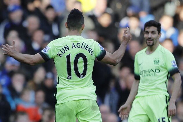 Manchester City's Sergio Aguero, left, celebrates after scoring the opening goal of the game during the English Premier League soccer match between Chelsea and Manchester City at Stamford Bridge stadium in London, Saturday, April 16,  2016. (AP Photo/Frank Augstein)