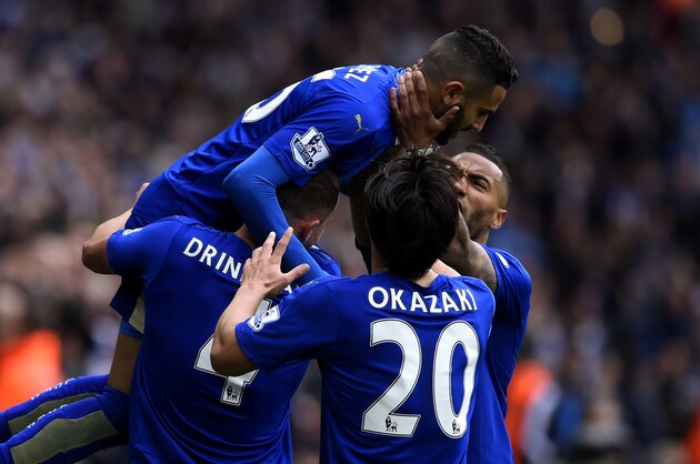 LEICESTER, ENGLAND - APRIL 24:  Riyad Mahrez of Leicester City (top) celebrates with team mates as he scores their first goal during the Barclays Premier League match between Leicester City and Swansea City at The King Power Stadium on April 24, 2016 in Leicester, United Kingdom.  (Photo by Mike Hewitt/Getty Images)