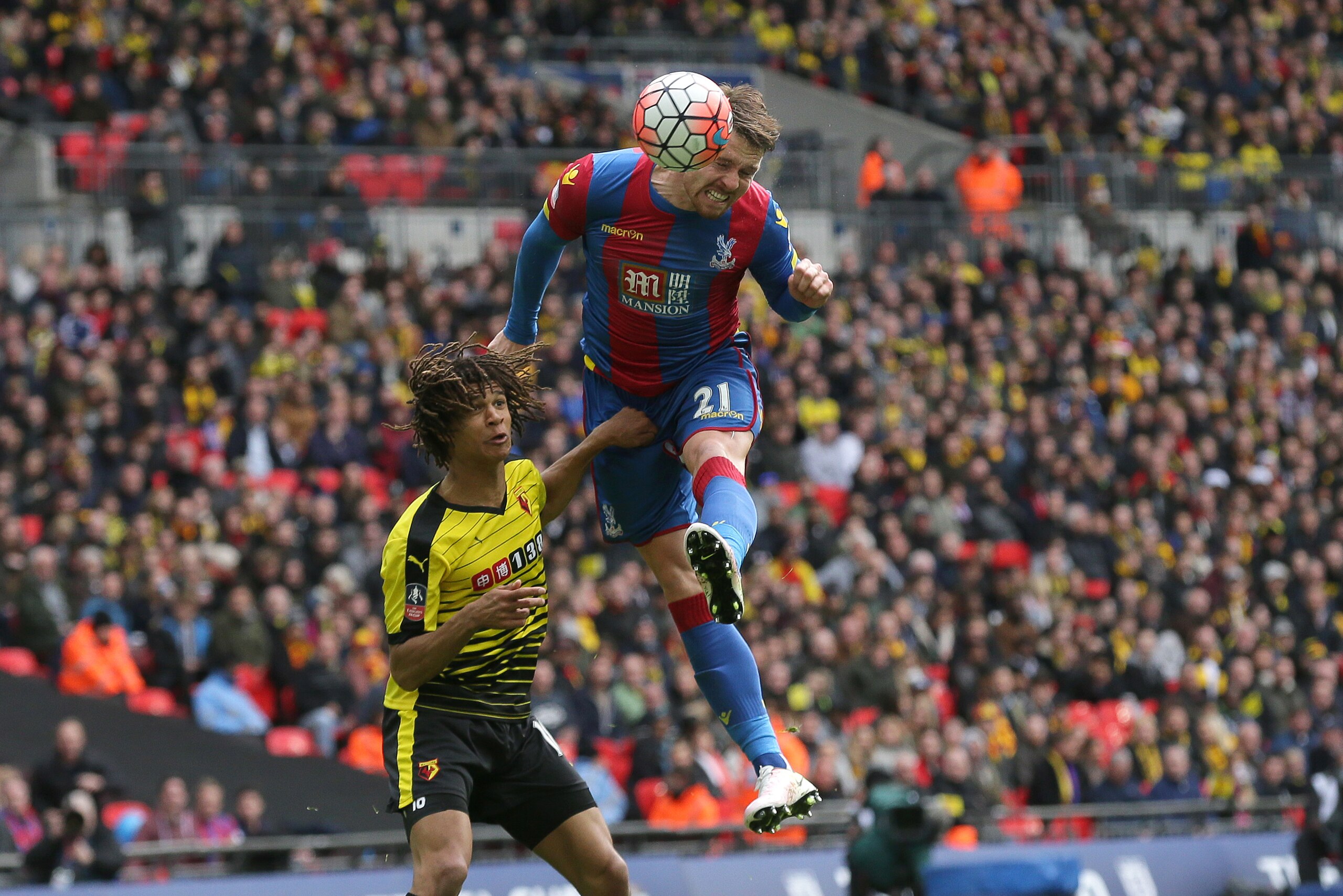 Crystal Palace's Connor Wickham, right, scores a goal beating Watford's Nathan Ake during the English FA Cup semifinal soccer match between Crystal Palace and Watford at Wembley stadium in London, Sunday April 24, 2016. (AP Photo/Tim Ireland)